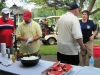 Golfers enjoy hot dogs at the turn