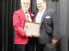 Enshrinee Tim Jenkins, right, accepts his plaque from Tom Skoch, LSHOF president