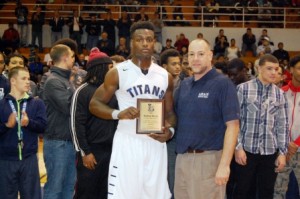 Lorain High School's Rashod Berry recently received a plaque honoring him for being named 1st Team Div. 1 All-Ohio Defense for his football achievements with the Titans this season. The plaque from the Lorain Sports Hall of Fame was presented by Bryan Koury, who is the Lorain Schools Athletic Director and an LSHOF Committee member. (Photo courtesy of Joe Bock, Lorain City Schools)