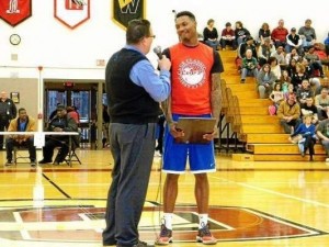 The Titans' Devon Andrews, right, accepts the Lorain County Mr. Basketball Award from Tim Alcorn, left, of AM930 WEOL. (Photo by Stephanie Metzger of The Morning Journal)