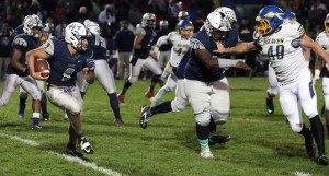 The Titans' Aaron Huff gains yards with blocking help from teammate Sly Worthy. (Morning Journal photo by Randy Meyers)